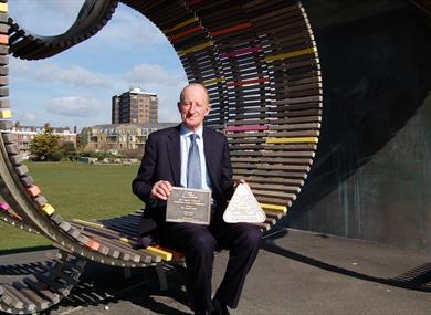 Councillor Norman Dingemans with the latest awards for Littlehampton's Long Bench