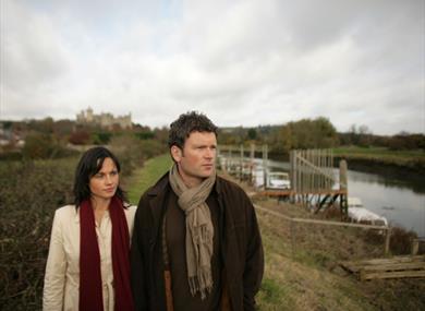 Couple walking along Arun river, West Sussex