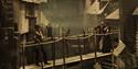 Photo of characters on bridge at Dickens World