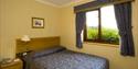 Lodge bedroom a short walk from Eynsham Hall
