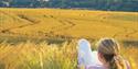 Woman relaxing in South Downs countryside