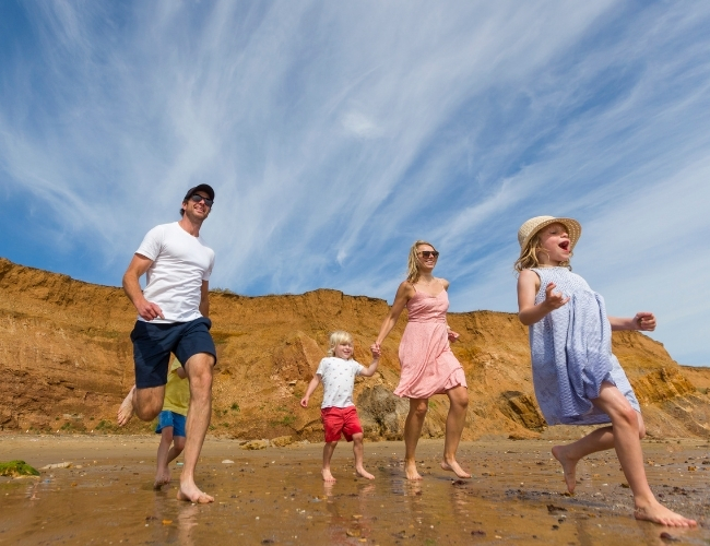 Family having fun on the award-wining beaches on the Isle of Wight